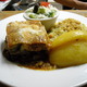 Layered eggplant, zucchini and potato topped with bechamel sauce - Moussaka at Acropol