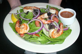 Spinach Salad Topped with Onion, Tomoato, Chopped Egg and Bacon Bits added shrimp for $2.00 extra at DuckTales Kitchen