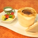 The coconut oatmeal is served in a coconut shell and topped with a brown sugar brulee.  - Coconut Oatmeal at Roots Gourmet