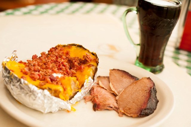 Stuffed Baked Potato with Sliced Brisket at Cokers Barbecue