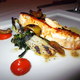 Grilled Wild Sturgeon with Spring Onion and Candied Olive, Romesco Sauce at Sanford Restaurant