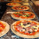 Thin Crust Oven Brick Pizza with Gourmet toppings. - Brick Oven Pizzas at Caffe Capri